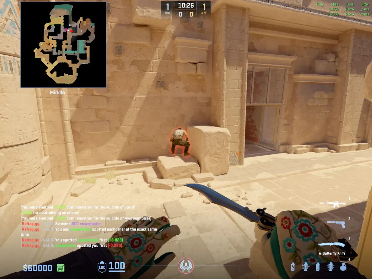 A CT crouches behind the Middle rock to hide from the approaching player.